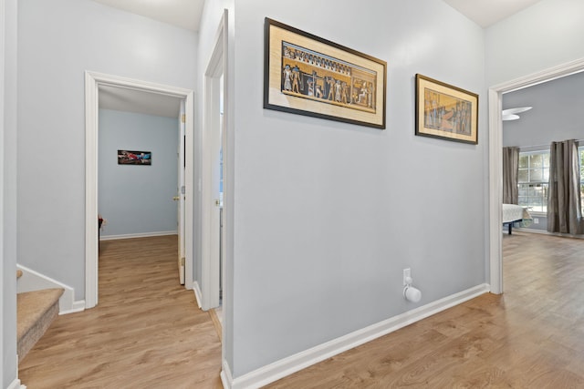 hallway with light hardwood / wood-style flooring