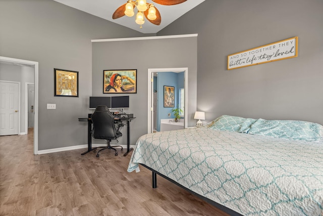 bedroom with ensuite bathroom, ceiling fan, high vaulted ceiling, and hardwood / wood-style flooring