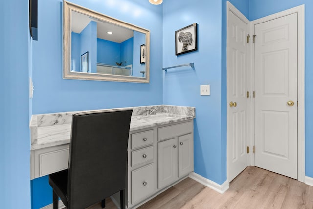 bathroom featuring wood-type flooring and vanity