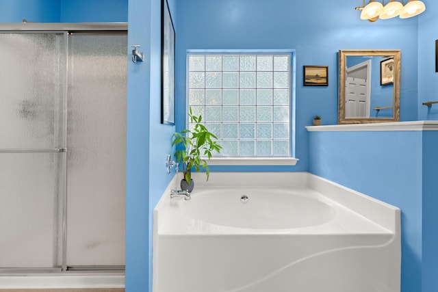 bathroom featuring independent shower and bath