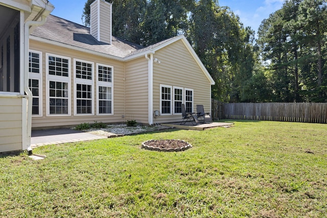 rear view of house with a patio area and a lawn