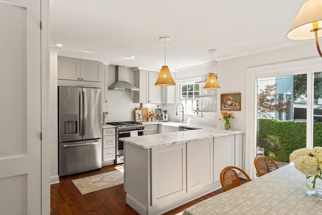 5 Smith St, Charleston, SC 29401 - kitchen with appliances with stainless steel finishes, wall chimney exhaust hood, a peninsula, a sink, and dark wood-type flooring