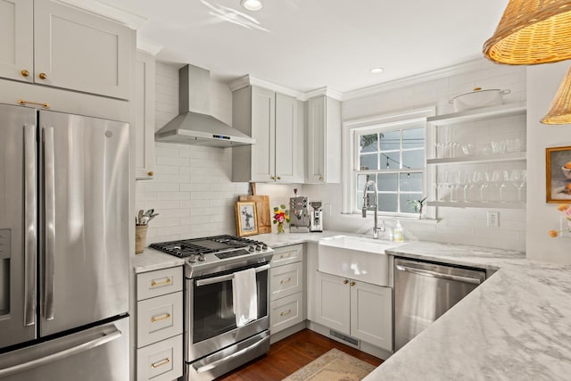 5 Smith St, Charleston, SC 29401 - kitchen featuring appliances with stainless steel finishes, wall chimney range hood, backsplash, dark wood finished floors, and crown molding