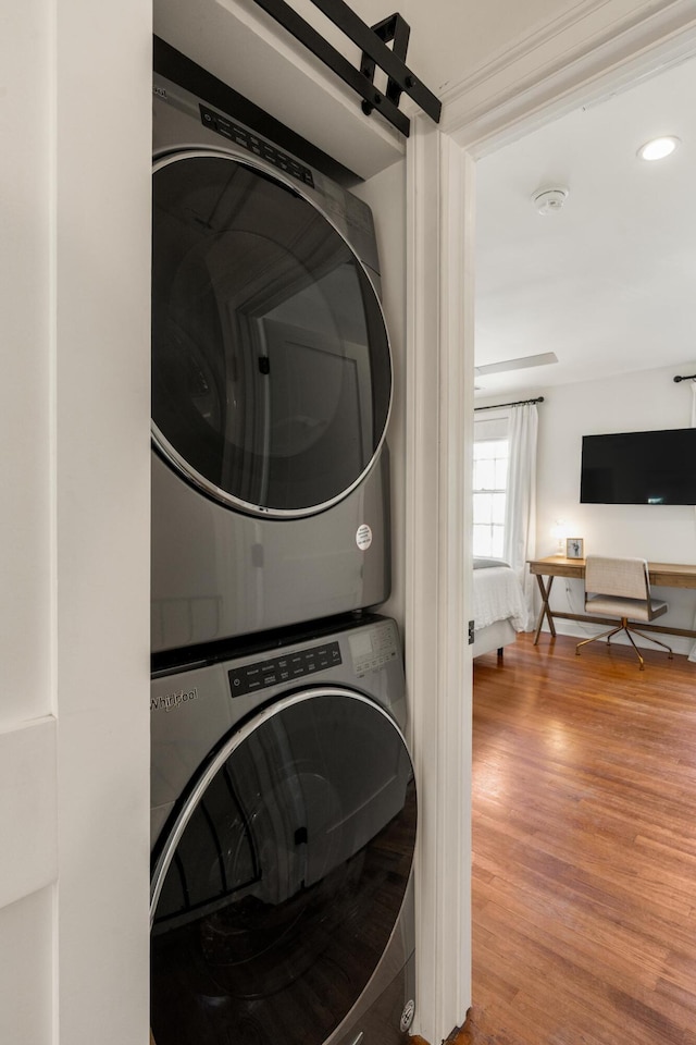 5 Smith St, Charleston, SC 29401 - laundry area featuring stacked washer and clothes dryer, wood finished floors, and recessed lighting