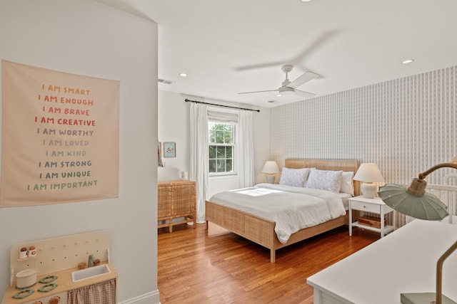 5 Smith St, Charleston, SC 29401 - bedroom with wallpapered walls, wood finished floors, ceiling fan, and baseboards