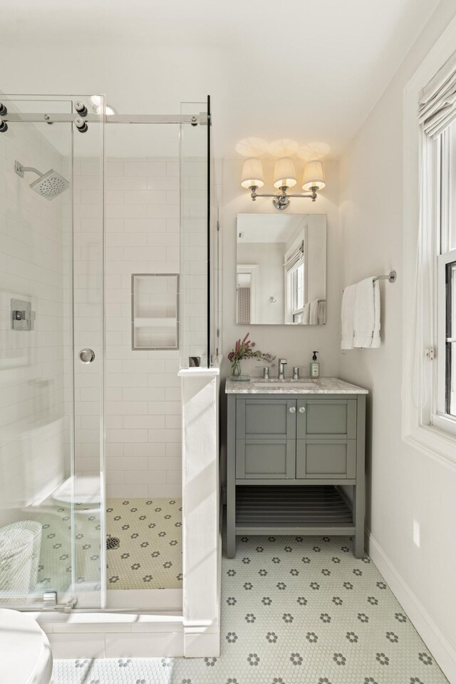 5 Smith St, Charleston, SC 29401 - bathroom featuring a shower stall, baseboards, and vanity