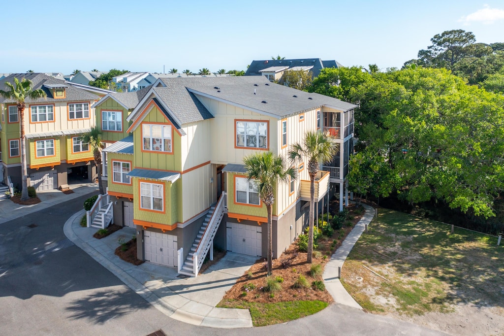 204 Michigan Ave Unit B3, Folly Beach, SC 29439 - view of front of home with an attached garage, stairway, roof with shingles, and driveway