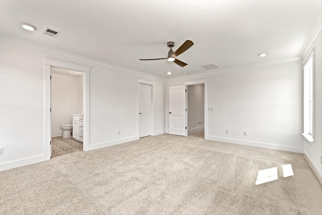 unfurnished bedroom featuring connected bathroom, ornamental molding, light carpet, and ceiling fan