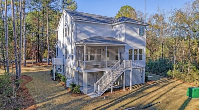 view of front of house with a sunroom and a front yard