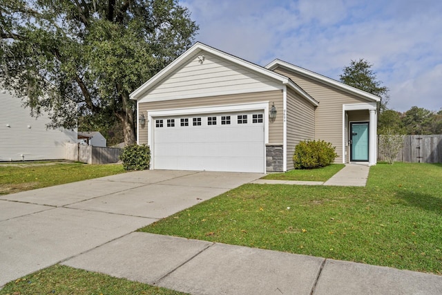 view of front of property featuring a front yard and a garage