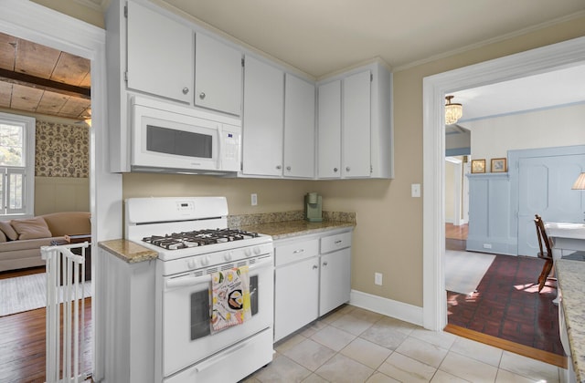 kitchen with white cabinetry, light tile patterned floors, white appliances, and wooden ceiling