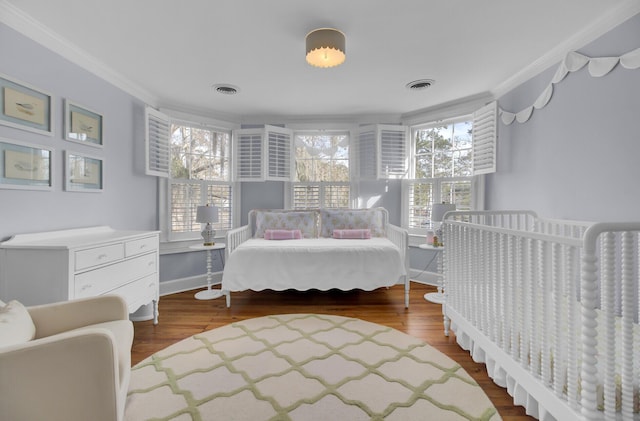 bedroom featuring hardwood / wood-style flooring and crown molding