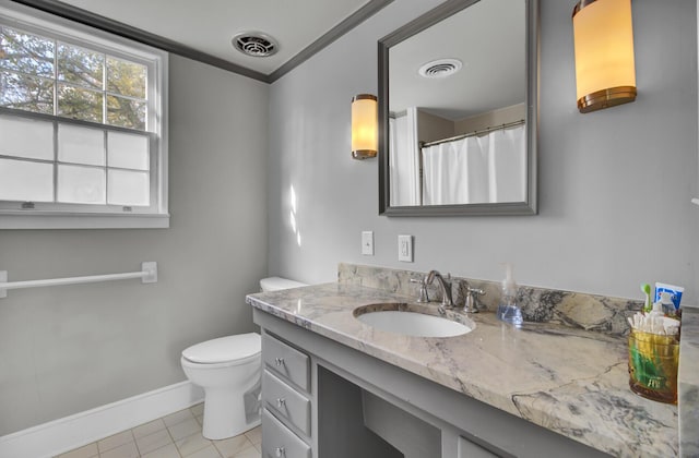 bathroom with vanity, tile patterned floors, crown molding, and toilet