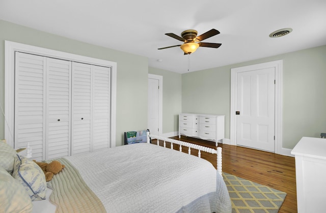 bedroom with ceiling fan, wood-type flooring, and a closet