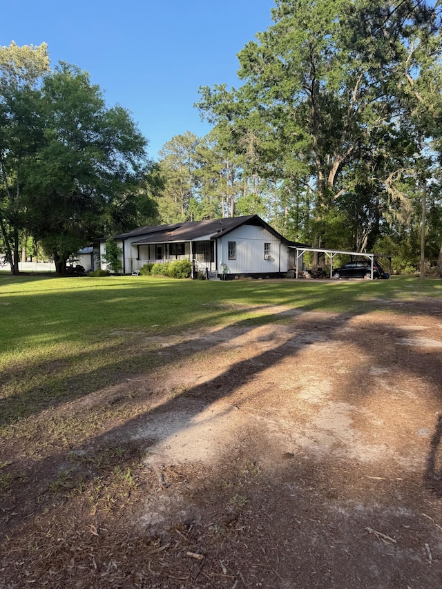 3637 Prices Bridge Ln, Walterboro, SC 29488 - view of property exterior featuring a lawn, a carport, driveway, and view of scattered trees