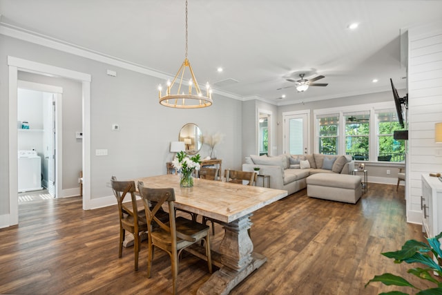 dining space with dark wood-type flooring, ceiling fan with notable chandelier, washer / clothes dryer, and crown molding