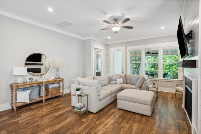 living room featuring dark hardwood / wood-style floors, ceiling fan, and crown molding