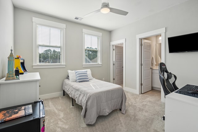 carpeted bedroom with ceiling fan and ensuite bathroom