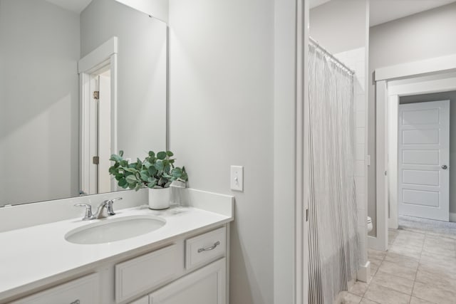 bathroom with tile patterned floors, vanity, and toilet