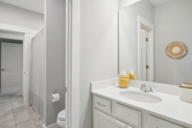 bathroom with tile patterned floors, vanity, and toilet