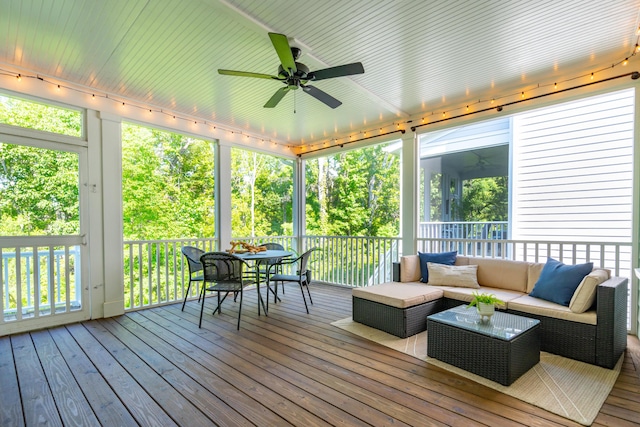 sunroom / solarium featuring ceiling fan