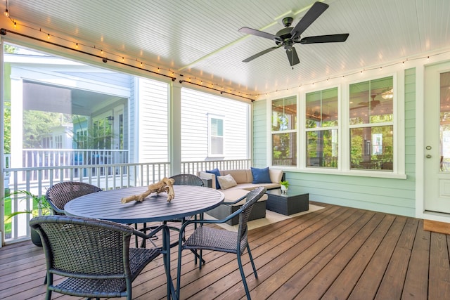 sunroom / solarium featuring ceiling fan