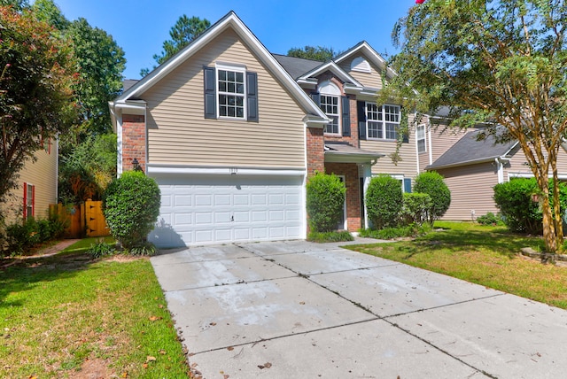 view of front of property featuring a front yard and a garage