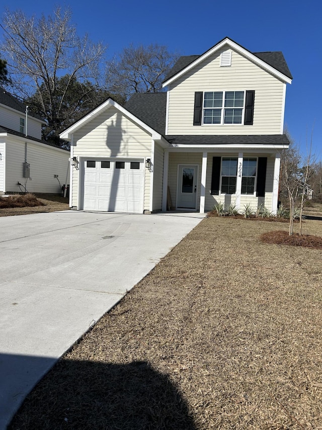 traditional home featuring an attached garage, concrete driveway, and roof with shingles