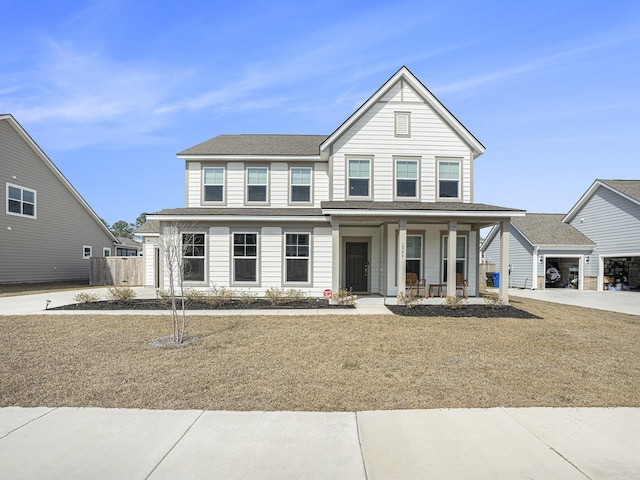 traditional home featuring a garage, driveway, and a porch