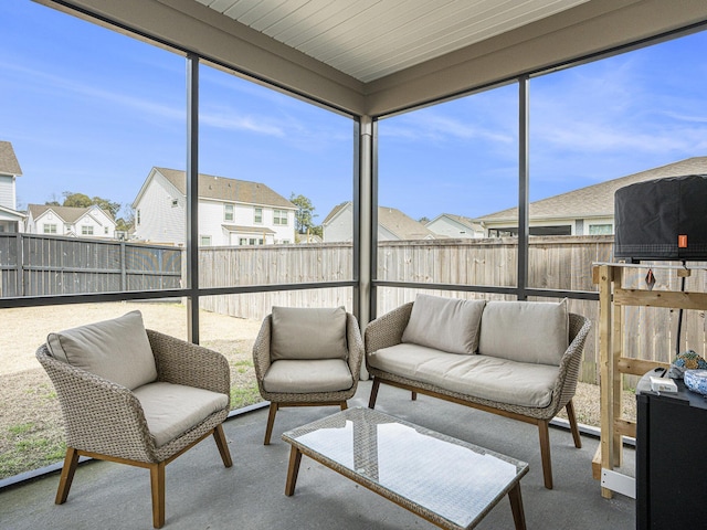 sunroom / solarium featuring a residential view