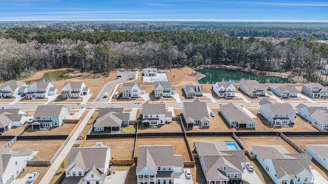 drone / aerial view featuring a residential view and a water view