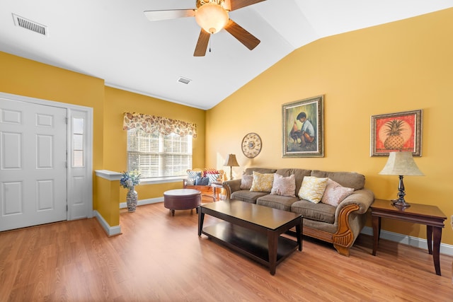 living room featuring ceiling fan, vaulted ceiling, and light hardwood / wood-style flooring