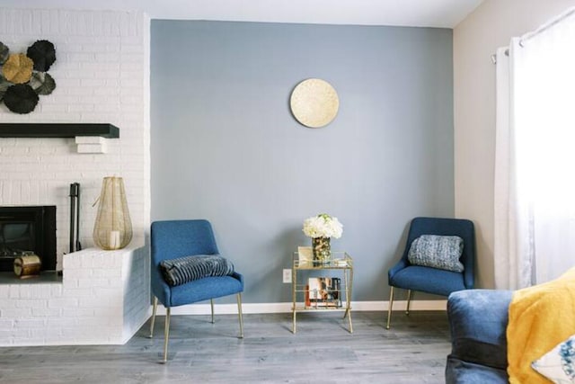 living area featuring baseboards and wood finished floors