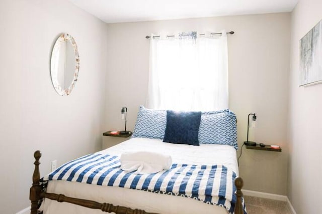 bedroom with baseboards and carpet flooring