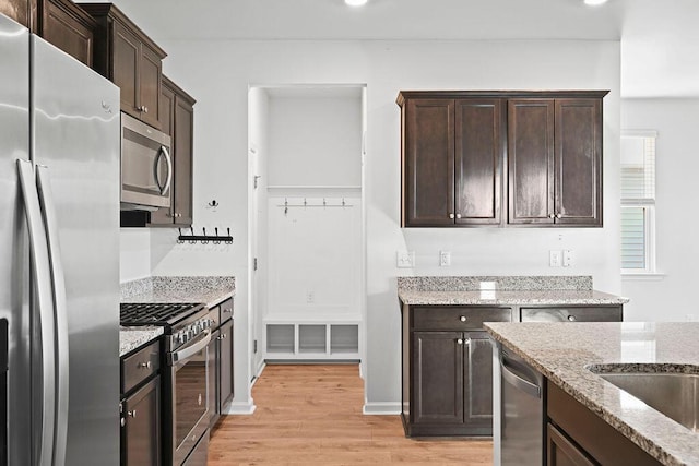 261 Celestial Blvd, Summerville, SC 29486 - kitchen with stainless steel appliances, light wood-style floors, dark brown cabinets, and recessed lighting