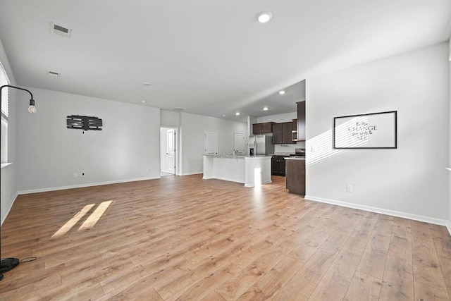 261 Celestial Blvd, Summerville, SC 29486 - unfurnished living room featuring light wood-style flooring, baseboards, and recessed lighting