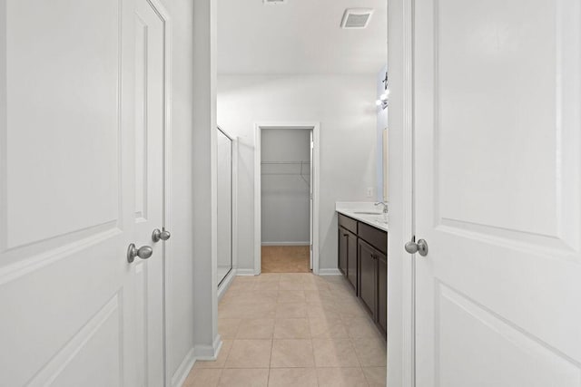 261 Celestial Blvd, Summerville, SC 29486 - bathroom with tile patterned floors, a spacious closet, vanity, a shower stall, and baseboards