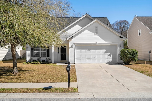 view of front of house featuring driveway, a front lawn, and an attached garage