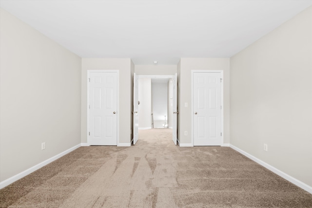 unfurnished bedroom featuring carpet flooring and baseboards