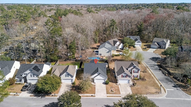 birds eye view of property featuring a residential view and a view of trees