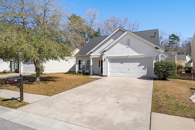 view of front of house with a garage, a shingled roof, concrete driveway, and a front yard