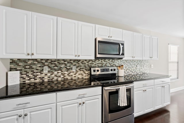 kitchen featuring appliances with stainless steel finishes, backsplash, and white cabinets