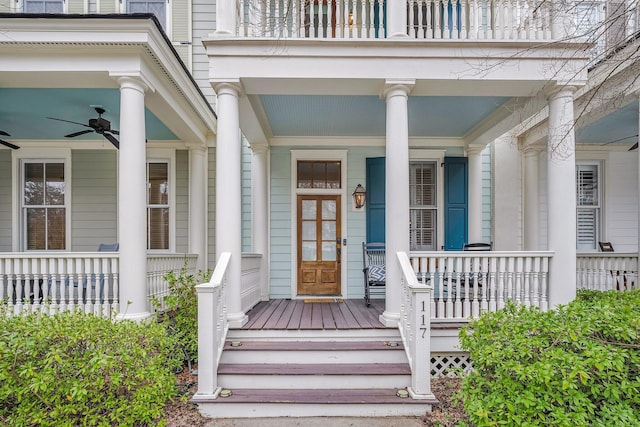 view of exterior entry with ceiling fan and a porch