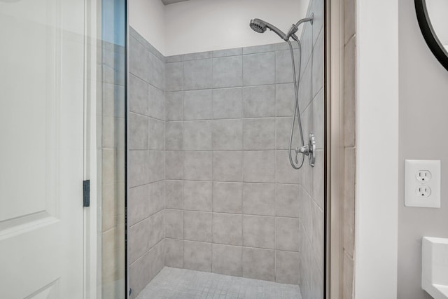 bathroom featuring a shower with shower door