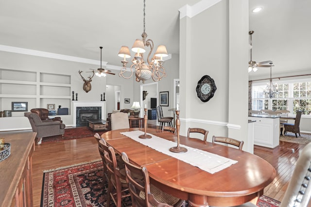 2257 Magnolia Meadows Dr, Mount Pleasant, SC 29464 - dining space featuring ceiling fan, a chandelier, wood finished floors, ornamental molding, and a towering ceiling