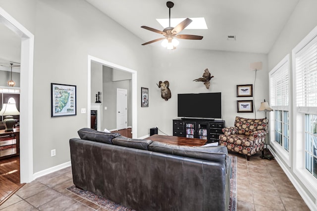 2257 Magnolia Meadows Dr, Mount Pleasant, SC 29464 - tiled living room featuring lofted ceiling, healthy amount of natural light, a ceiling fan, and baseboards