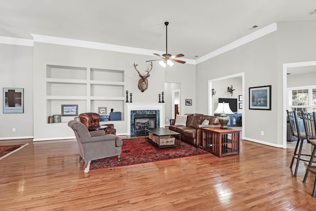 2257 Magnolia Meadows Dr, Mount Pleasant, SC 29464 - living area with built in features, wood finished floors, crown molding, a ceiling fan, and baseboards