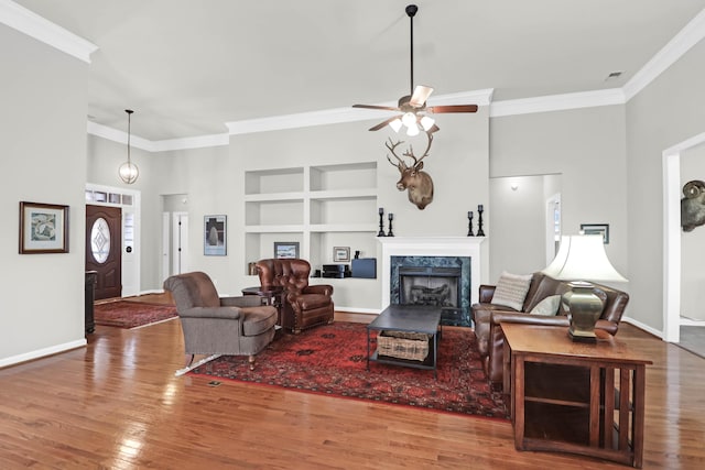 2257 Magnolia Meadows Dr, Mount Pleasant, SC 29464 - living room with built in features, crown molding, a ceiling fan, wood finished floors, and baseboards