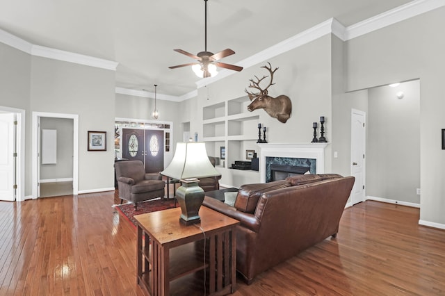 2257 Magnolia Meadows Dr, Mount Pleasant, SC 29464 - living room with built in features, a premium fireplace, a ceiling fan, hardwood / wood-style floors, and crown molding