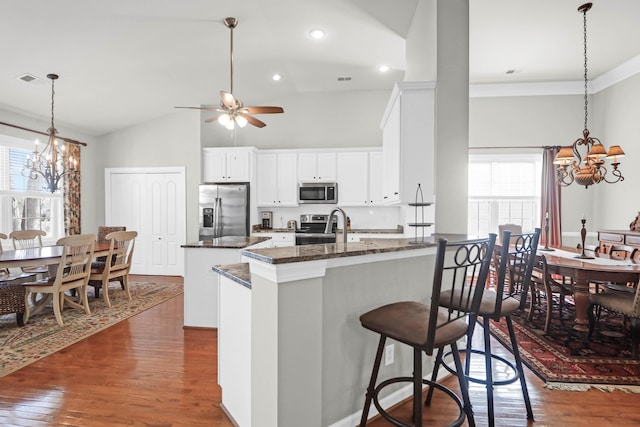 2257 Magnolia Meadows Dr, Mount Pleasant, SC 29464 - kitchen with a chandelier, appliances with stainless steel finishes, dark wood finished floors, a peninsula, and recessed lighting
